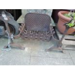 A cast iron fire basket and combined pronounced dogs with spear head finials