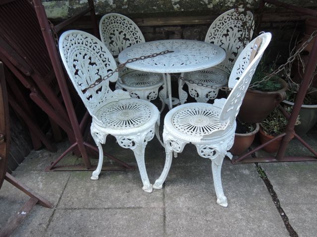 A Victorian style cast aluminium terrace set comprising circular top occasional table with