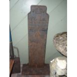 A cast iron marker with relief lettering ER flanking a crown and initialled for feet & inches