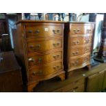 A pair of reproduction yew wood veneered four drawer bedside chests in the Georgian style with