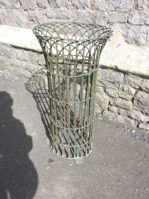 A Victorian wirework planter of cylindrical form with three flattened shaped feet