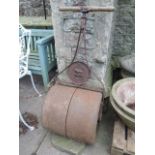 A vintage cast iron garden roller with circular plaque, "the Sterling" with lion trademark