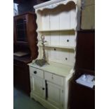 A small painted pine kitchen dresser, the base enclosed by a pair of panelled doors beneath two