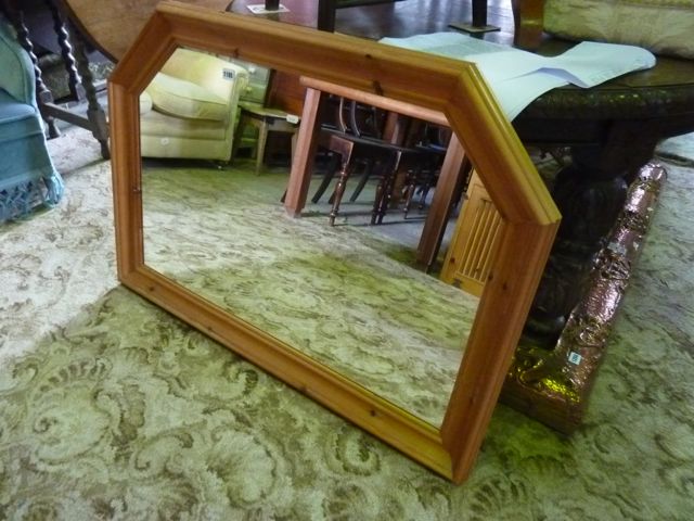 A wall mirror of rectangular form with moulded  pine partially canted frame
