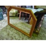 A wall mirror of rectangular form with moulded  pine partially canted frame