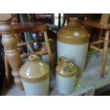 A collection of vintage stoneware flagons and jars of varying capacity, three with merchants marks