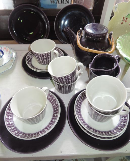 A collection of Swedish Variant Percy pattern tea wares with dark aubergine coloured glaze and