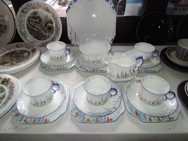 A collection of Carlton China Art Deco tea wares with painted cottage garden type decoration