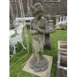 A large weathered cast composition stone ornament in the form of a classical maiden in standing pose