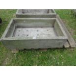 A weathered cast composition stone trough of rectangular form, 87 x54 cm approximately