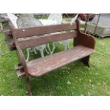 A weathered teak two seat garden bench with pegged frame