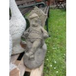 A contemporary weathered cast composition stone garden ornament in the form of a garden gnome