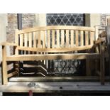 A good quality contemporary teak three seat garden bench with slatted seat and oval slatted back