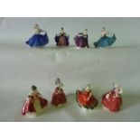 A collection of eight small Royal Doulton figures comprising Elaine in blue colourway HN3214, Elaine