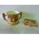 A loving cup in the Royal Worcester manner with gilded lion handles and finely painted decoration