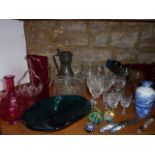 A collection of glassware to include five Harlequin hock wines, a cranberry glass carafe, a