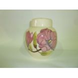 A Moorcroft cream ground Magnolia pattern ginger jar and cover with impressed mark to base, 20 cm