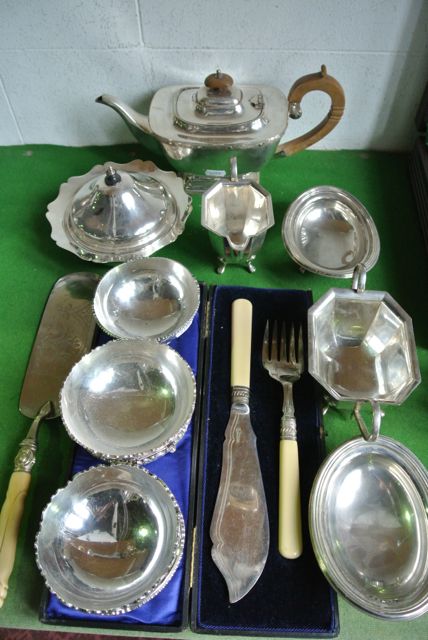 A good quality silver plated sugar basin and milk jug, a further teapot, two egg shaped bon bon