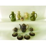 A collection of oriental black ground eggshell porcelain coffee wares with gilt landscape decoration