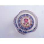 A six faceted Perthshire Millefiori paperweight dated 1997 decorated with a central floral study