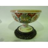 A 19th century oriental bowl of circular form raised on a circular foot, with polychrome painted