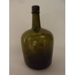 A 19th century glass wine bottle of mallet form with simple tapering cylindrical neck and rim,