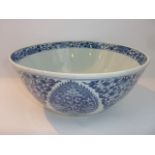 A 19th century oriental blue and white punch bowl with alternating panels of flowers and foliage,