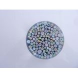 A good quality milliefori glass paperweight, decorated well formed and separated canes and stars