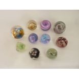 A selection of ten glass decorative glass paperweights to include seven Caithness examples -