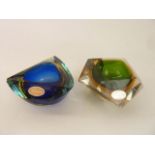Two 20th century Murano glass ashtrays, one of faceted form with a green well with further amber