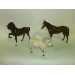 A collection of three Royal Doulton equestrian figures comprising a Shetland Pony with dappled