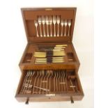 A walnut veneered canteen with hinged lid set above a single drawer containing a quantity of rat