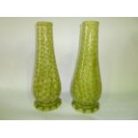 A pair of early 20th century Burmantofts Faience green glazed vases of tapering form with unusual