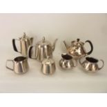 A four piece stainless steel tea set comprising teapot, hot water pot, lidded sugar basin and milk