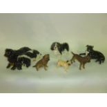 A collection of ceramic dogs including a Beswick example of a Cavalier King Charles Spaniel, a