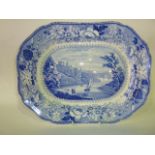 An early 19th century blue and white printed meat plate of oval form with central landscape panel