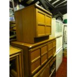 A teak two sectional low side cupboard, possibly Nathan, enclosed by quarter panelled doors