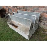 Three reclaimed galvanised steel wall mounted water troughs of rectangular wedge shaped form