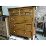 A good quality reproduction oak bedroom chest of three long and two short drawers with linen fold