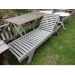 A good quality weathered contemporary teak garden lounger with slatted seat and adjustable head rest