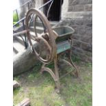 A vintage cast iron agricultural hand wheel driven chaff cutter with timber shute, stamped C M23