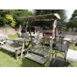 A good quality weathered contemporary teak garden swing, with domed slatted canopy raised on a