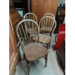A set of four elm and beechwood hoop and stickback kitchen chairs raised on turned supports and