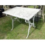 A cast aluminium garden table, the rectangular quarter panelled top with decorative pierced