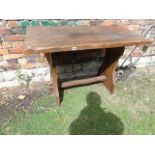 A small stained elm refectory type table, the rectangular top raised on shaped slab end supports