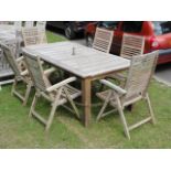 A Laura Ashley Outdoor Living contemporary weathered teak garden table of rectangular form raised on