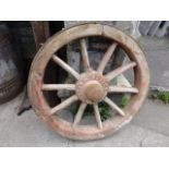 A vintage wooden spoke agricultural wheel with iron rim and hub stamped W Foster & Co Ltd,