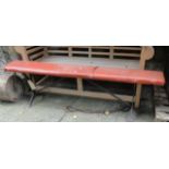 A vintage cast iron bench with wooden plank seat (later covered), 6ft long approximately and a