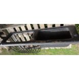 A vintage cast iron wall mounted stable manger and combined feeding trough