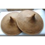 A pair of woven wicker coolie hats